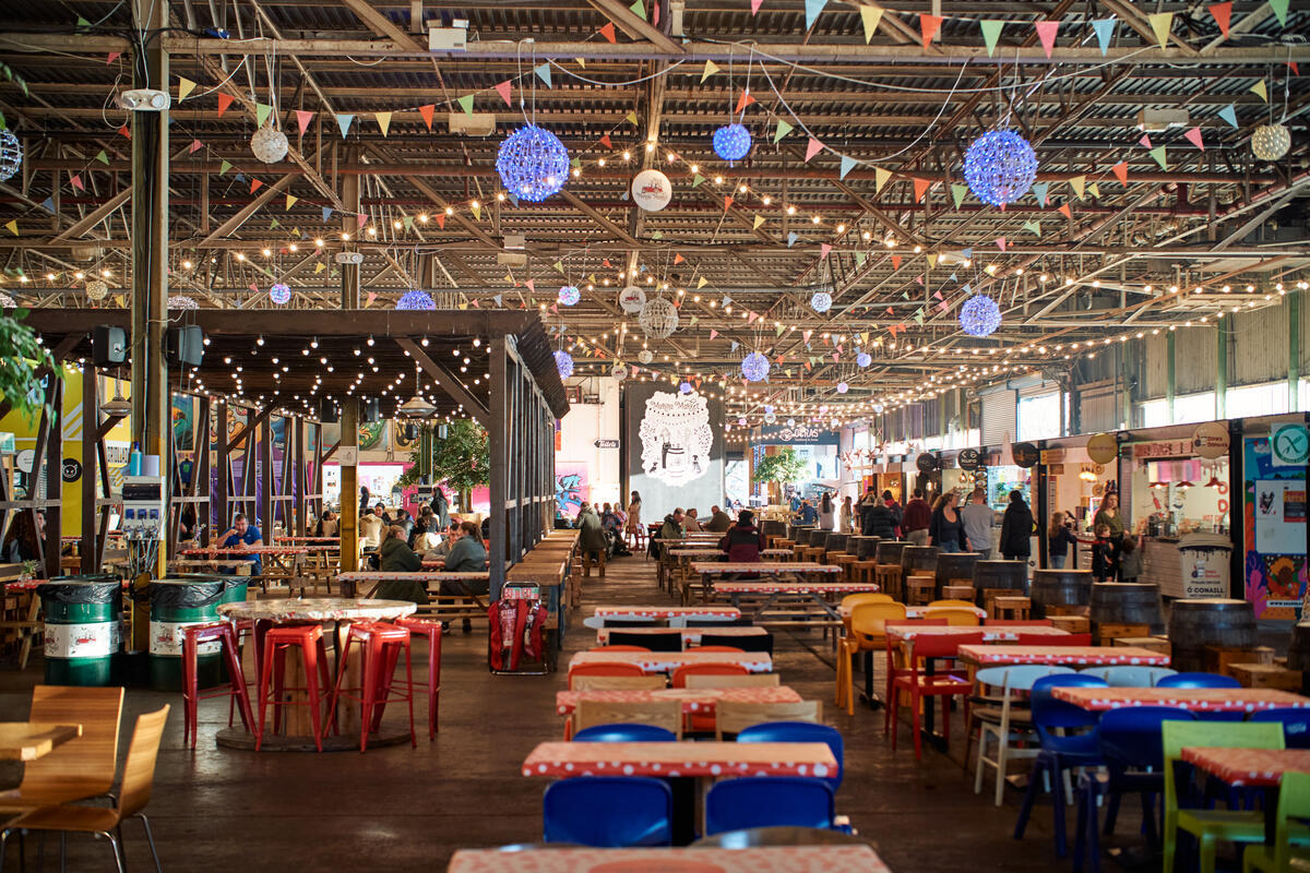 Inside Marina Market in Cork with communal tables and independent food traders